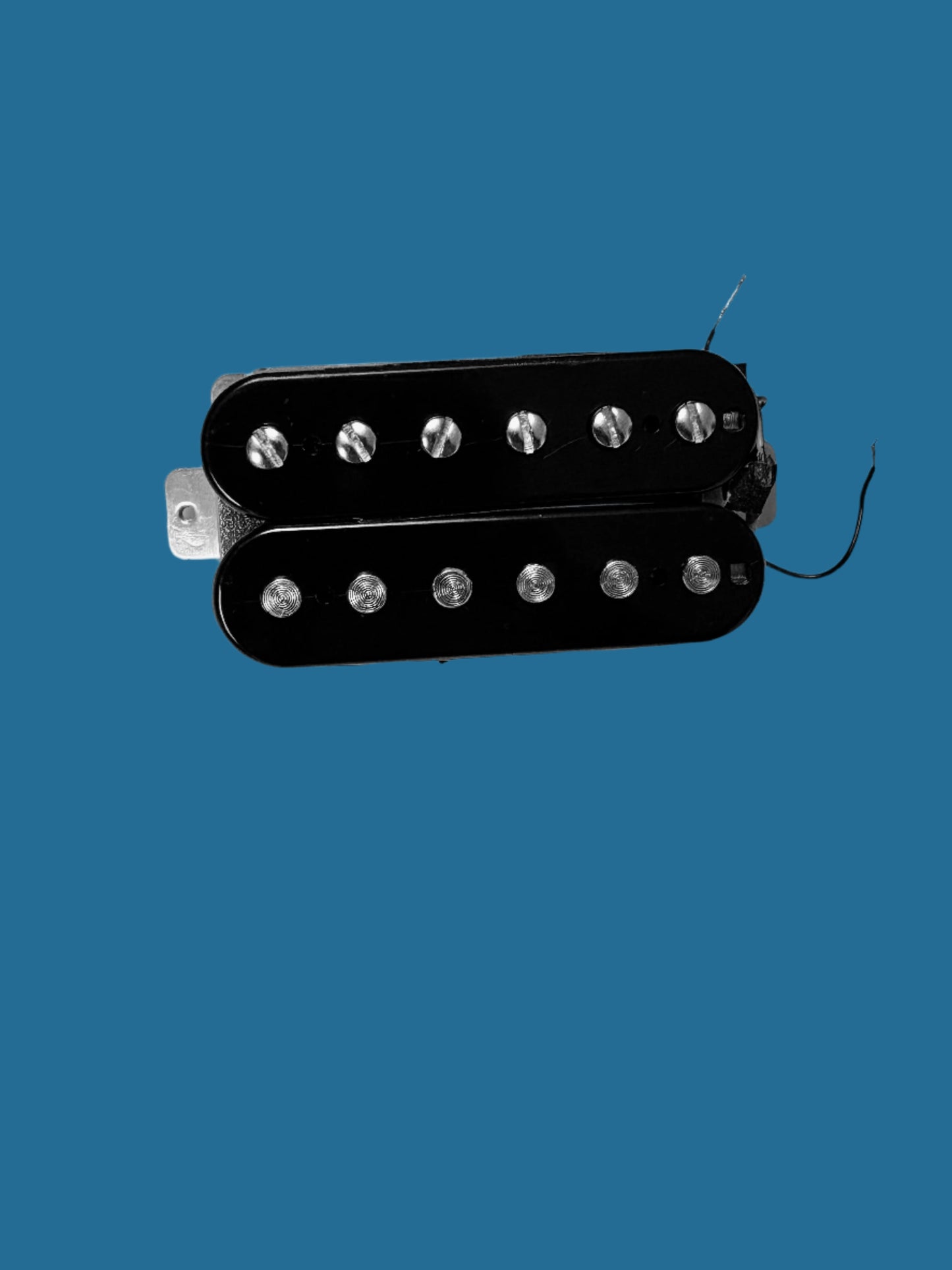 A black PAF-style humbucker guitar pickup with visible wire wound around a pole, set against a blue background.